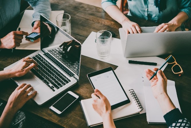 Several office workers on laptops