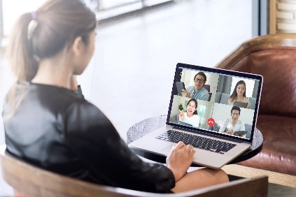 Individual using laptop for a virtual meeting